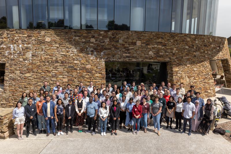 Photograph showing all the members of the consortium who attended the annual meeting at Cape Shanck. They are standing outside in bright sunlight.